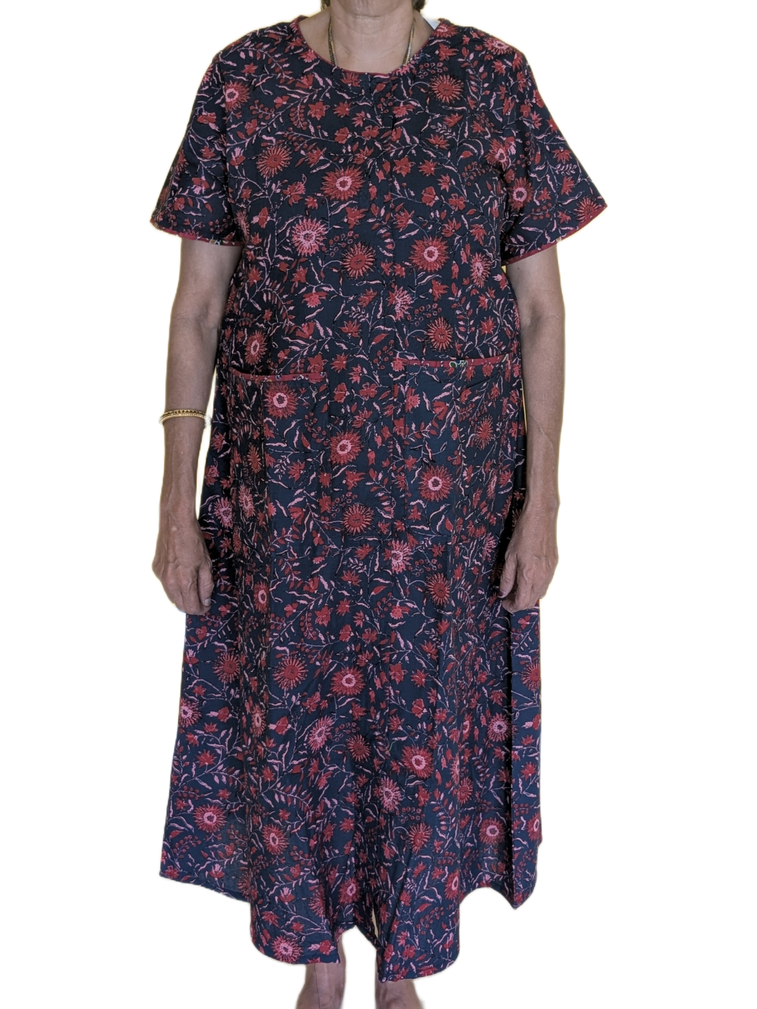 Person wearing a dark floral dress on a white background
