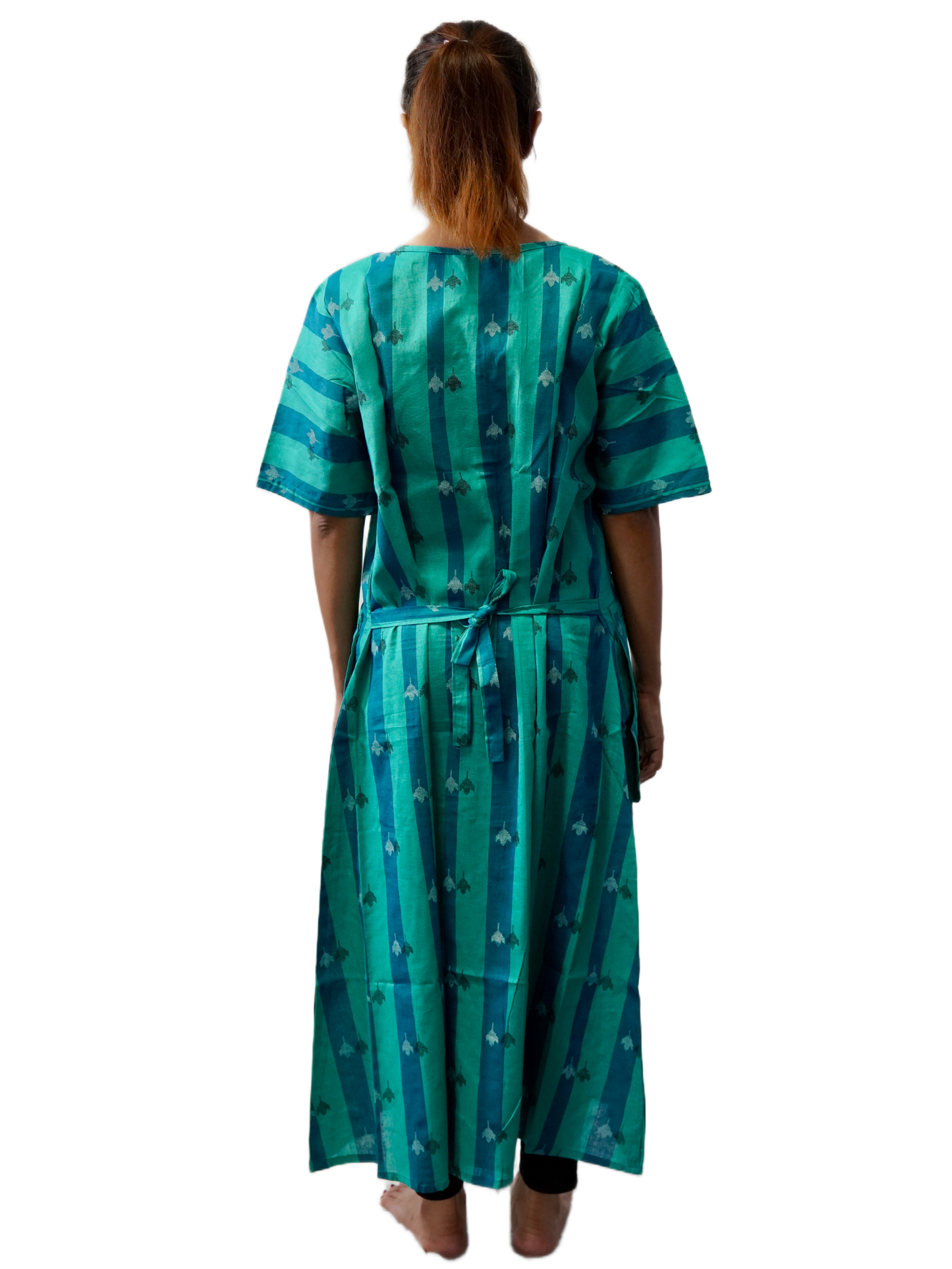 Woman wearing a green patterned dress on a white background
