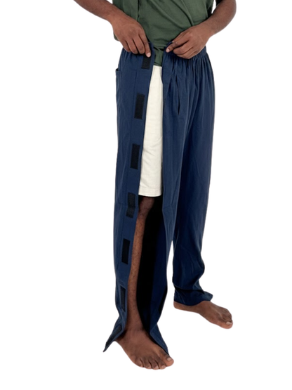 Person wearing a long navy blue garment with black square patterns on a white background