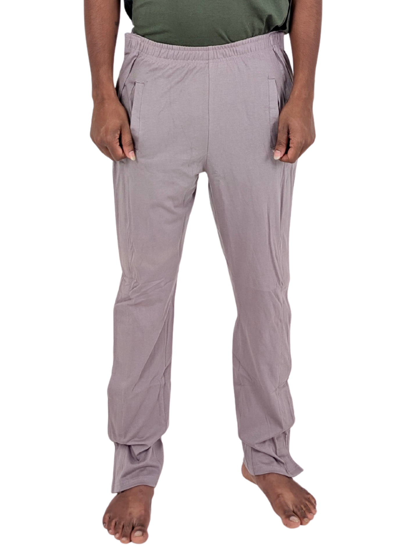 Person wearing light gray pants on a white background
