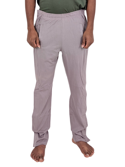 Person wearing light gray pants on a white background