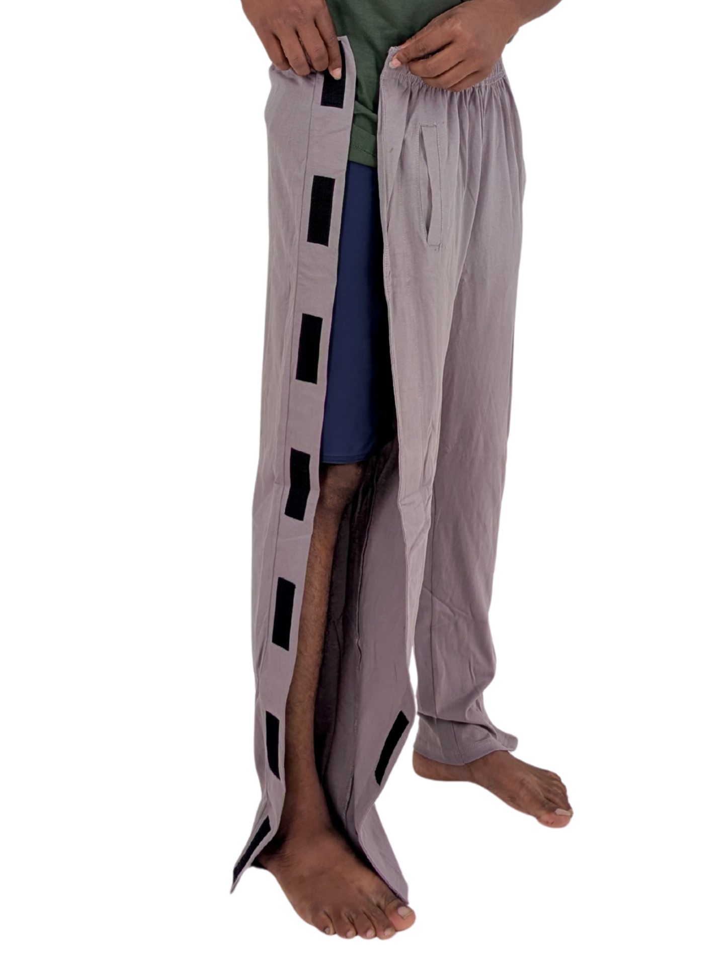 Person wearing a unique pants design with side open patterns on a white background