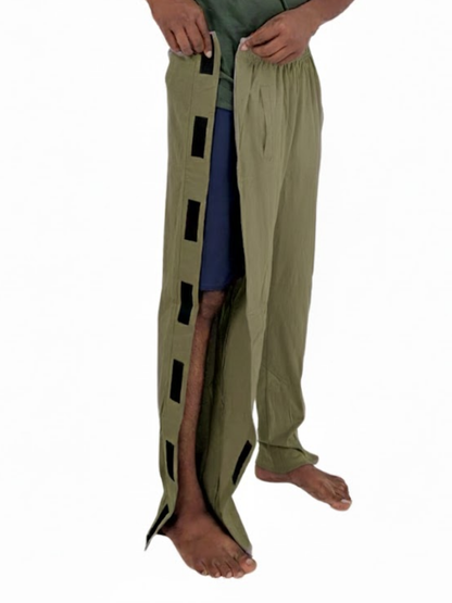 Person wearing a pair of green pants with side opening on a white background