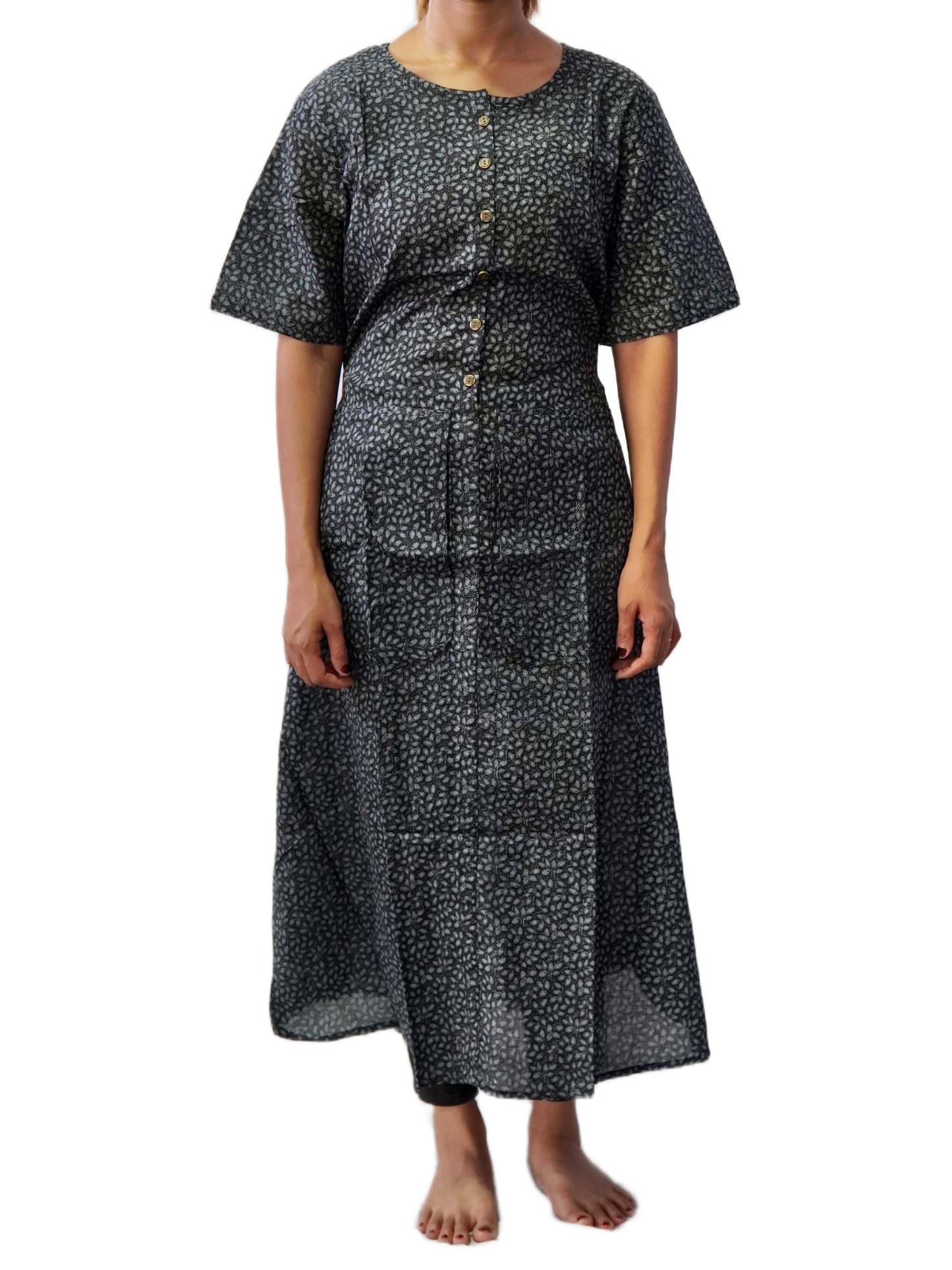 Person wearing a black patterned dress on a white background