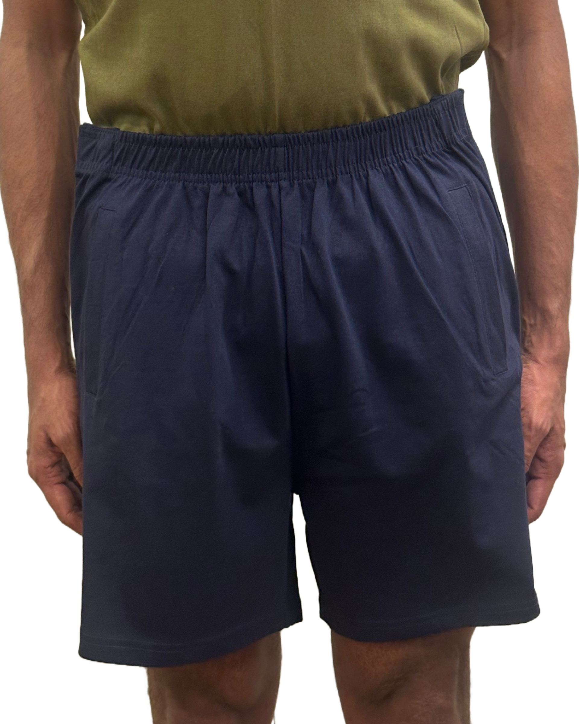Male standing with relaxed arms wearing a green T-shirt showcasing adaptive wear blue shorts.